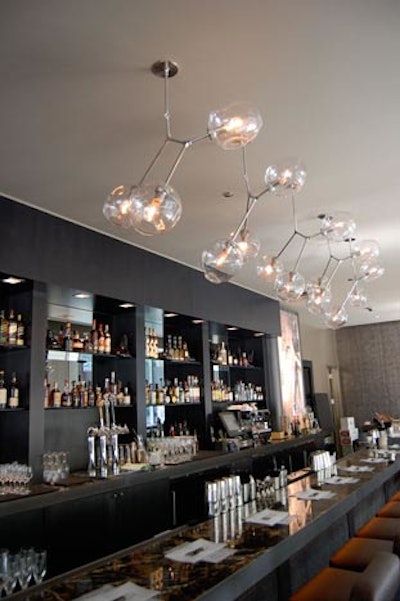 Molecules inspired the design of a hand-blown glass chandelier that hangs above the bar.