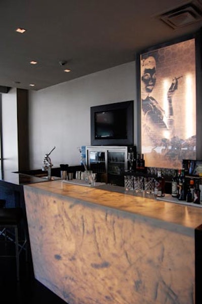 Lead bartender Mike Ryan, formerly of the Violet Hour, prepares hand-crafted cocktails at an illuminated onyx bar.