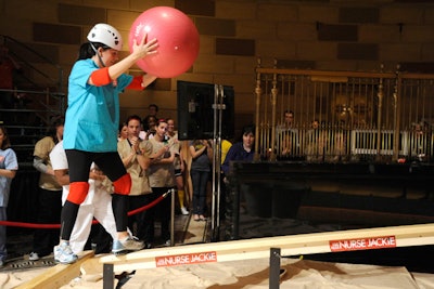 Participants made their way down a five-inch balance beam to place a medicine ball in a bucket at the end.