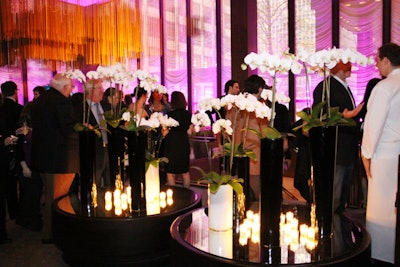 Decor was kept simple with tall vases of white orchids and pink lighting that illuminated the restaurant's metal chain drapery.