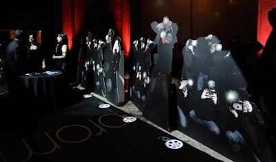 Guests walked a black carpet flanked by cutouts of paparazzi.