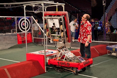 Competition M.C. David Price checked out a robot after a match.