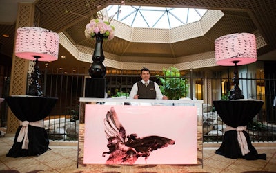 The cover of the current CS Brides—which showcases pink and peach tones, tulle, and chiffon—inspired the look of the cocktail area. A photo of the Eros statue in London decorated the bar.