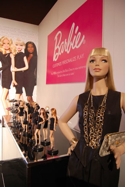 At a display from event sponsor Barbie, guests can accessorize and personalize Barbie Basics dolls, each of which is clad in a little black dress.