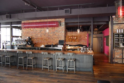 The bar surrounding the island and kitchen, in the centre of the space, was crafted with reclaimed wood from the Gooderham & Worts whiskey distillery.