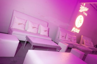 Room Service by AFR Event Furnishings provided white leather lounge furniture and pillows that DesignScene branded with the Miller Genuine Draft logo.
