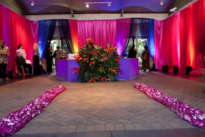 A pathway made of orchids and uplit drapes decorated the check-in area.