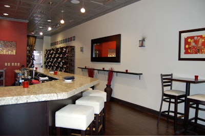 The 10-seat bar is topped with a thick slab of neutral colored granite.