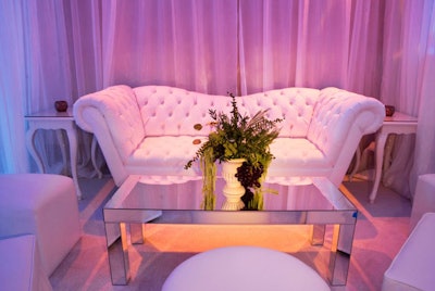 White tufted seating and mirrored tabletops decorated the party.