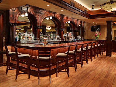 Mirrored ornamental arches back the bar.