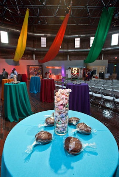 Highboy tables were covered in bright fabric and topped with edible decor: taffy-filled glass centerpieces and whoopee pies by Bakers' Best Catering.