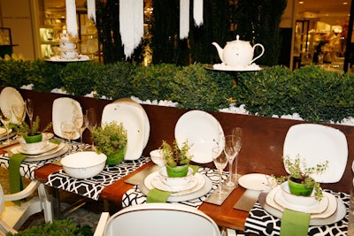 To spruce up a Lennox china display, Garner planted a boxwood hedge down the length of the table and put an individual plant at each place setting.