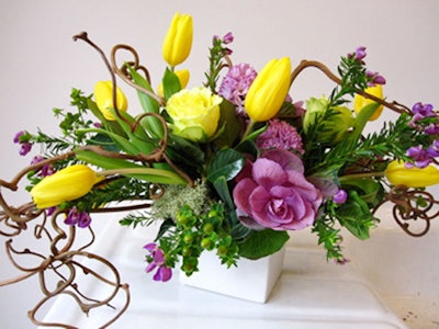 Christine Noelle uses flowers including kiwi vines, kale, roses, tulips, hyacinth, and hypericum berries.