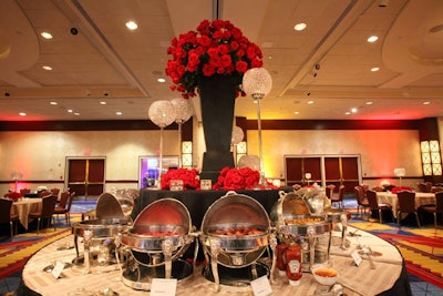 Red roses and crystal globes decorated buffet stations with breakfast foods like chicken-apple sausage, cheese blintzes, bacon, and frittatas.