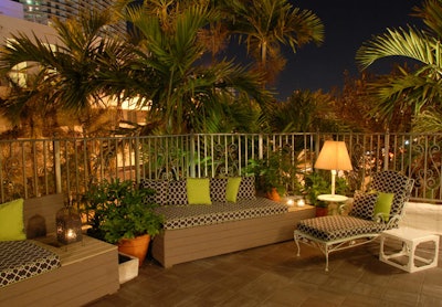 The terrace looks out on the tops of palm trees.