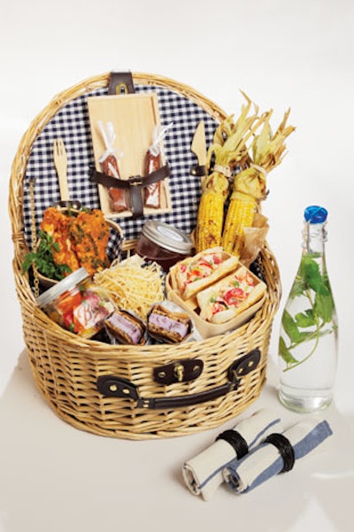 Lobster rolls, fried chicken, Caprese salad, frozen chipwich, roasted corn, and mint-flavored water in a picnic basket from Callahan Catering in New York