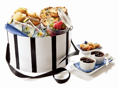 Spinach, ham, and Gruyère tarts, mini orange muffins with smoked turkey, strawberries with Devon cream and sugar, chocolate pots de crème with chocolate-covered coffee beans, and smoked salmon éclairs in a hatbox from Well Dunn Catering in Washington