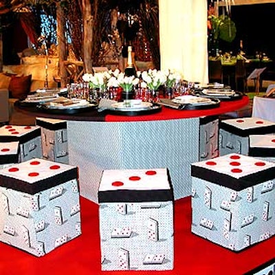 Todd Moore's chic playing-card-themed table for interior design company F. Schumacher & Company used small cube seats and a table covered with some of the company's signature fabrics.
