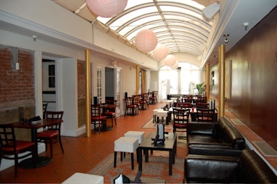 A glass barrel ceiling is the chief decor element in the long and narrow Atrium lounge, which seats 60 and holds 125 for reception.