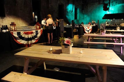 Small baskets filled with floral arrangements by Petals topped picnic tables.