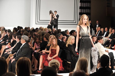 Guest seating for the fashion show surrounded a rectangular runway that incorporated the stage in the Carlu's Concert Hall.