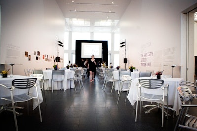 Guests sat at tables along the atrium, and the ceremony took place on a temporary stage up front.