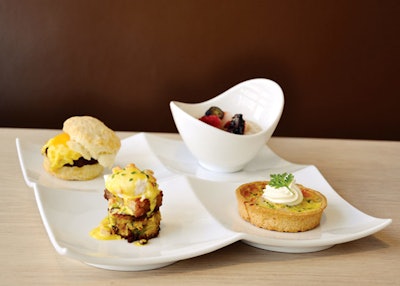 Mini breakfast of steel-cut Irish oatmeal with berries; quiche lorraine with crème fraîche; sausage, egg, and cheese biscuit sandwich; and a cheddar-potato cake with pork belly, poached quail egg, and sabayon from Lorien Hotel and Spa in Alexandria, Virginia.