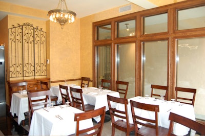 The 34-seat main dining room has granite floors, ochre-colored and Tuscan red brick walls, and wrought iron accents.