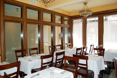 In the main dining room, windows are draped with sheer curtains and lighting comes from a series of Victorian style chandeliers.