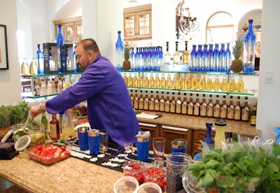 A bartender from Milagro tequila crafted specialty cocktails in a V.I.P. area inside the home used as the venue for the Anthem party.