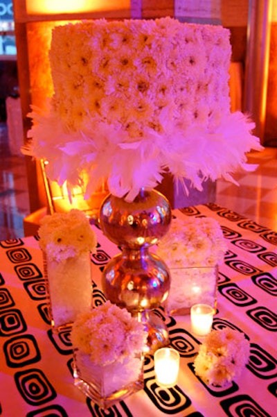 AOM's floral designers created three different centerpieces using white feathers, daisies, crystals, and tea lights.