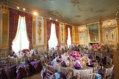 In the Salon Doré, gold Chiavari chairs with purple silk cushion covers and beaded lilac votives complemented the room's gilded floor to ceiling paneling. Low floral arrangements included purple garden roses, purple sweet peas, Mokara orchids, and spray roses.