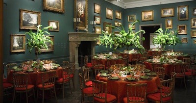 In the Mantel Room, layered Vanelie Amber with Brushed Fringe and Topaz Spice linens from Perfect Settings contrasted with Jack Lucky's green bouquets of green parrot tulips, green calla lilies, viburnum, green roses, green hydrangeas, and bells of Ireland.