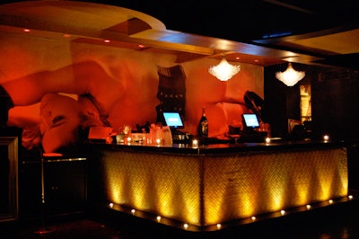 A black and white image of a burlesque dancer serves as the backdrop to the second floor's main bar.
