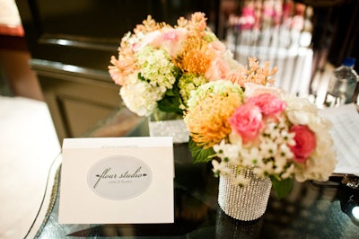 Silver vases held floral arrangements designed by Flour Studio.