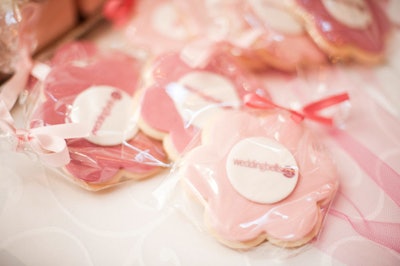 A dessert table featured a range of candies and sweets, including pink and white Weddingbells cookies.