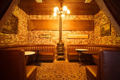 Exposed brick and leather banquettes add to a vintage atmosphere at the new Thirsty Crow.