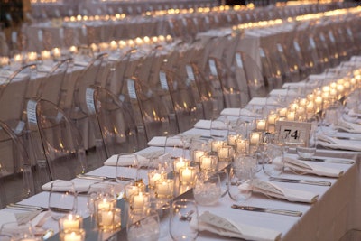 Lucite chairs, candles, and sleek white linens dressed the 150-foot tables.