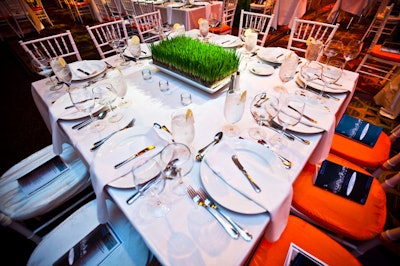 The decor included crisp white table linens and wheatgrass centerpieces.