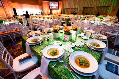 Some tables were covered with grass-patterned linens and potted begonia centerpieces to convey a feeling of spring.