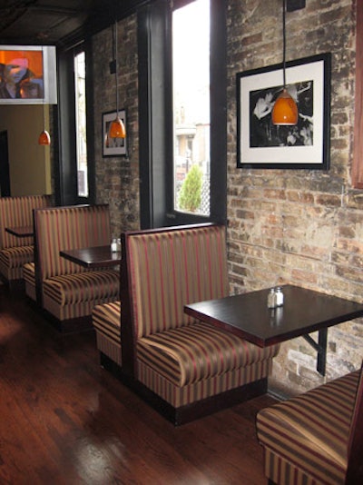 Exposed brick, hanging light fixtures, and black-and-white photos deck the interior of Temple Bar.