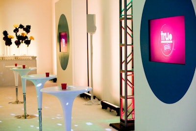 All the furniture used in the cocktail and lounge areas was white, allowing the flowers, votives, and other decor items to provide subtle hints of the brand's signature colors.