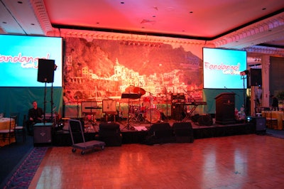 A mural depicting the Amalfi Coast provided a backdrop for the stage.