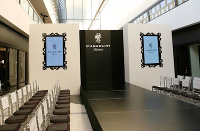 Video screens surrounded by black decorative frames flanked the runway.
