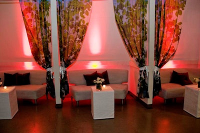 Designers from Revel Global Events created cabanas with custom pillows. The seating areas filled spaces that are ordinarily used for prop storage.