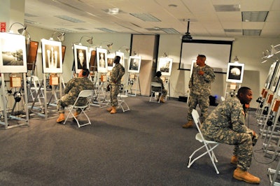Local military personnel checked out the Michael Nye exhibit, which had headphones with each photo to tell the subjects' stories of their experiences with hunger.