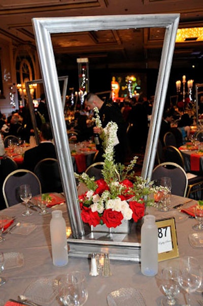 Kehoe designed three tabletop decor schemes for the dinner in the International ballroom. One design incorporated illuminated mirror boxes with red roses and white spray roses.