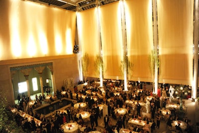 Following cocktails in the Carroll and Milton Petrie European Sculpture Court, dinner for 725 guests was served in the Charles Engelhard Court. Nathan Crowley and Raul Avila created the illusion of a summer sunset using hundreds of yards of yellow silk hung from the ceiling.