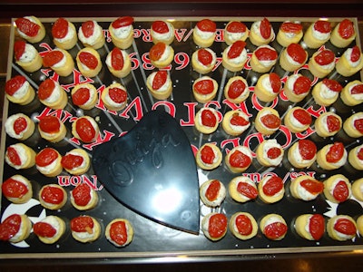 Gourmet Cuisine used a ouija board as a serving tray for its mini polenta rounds with herbed ricotta and oven roasted grape tomato.