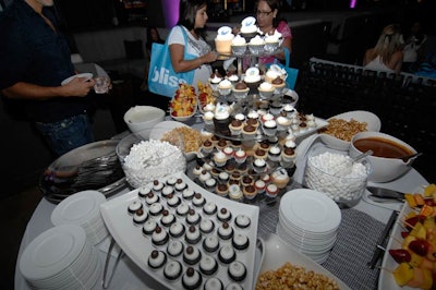 The hotel and Stella's Sweet Shoppe set up a table of treats like mini cupcakes, fruit skewers, mini marshmallows, and caramel corn along with melted chocolate and caramel sauce for dipping.